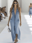 Light blue denim sleeveless jumpsuit by FJØRNA featuring raw edges and wide-leg design, displayed on a hanger.
