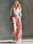 Pink cotton linen wide-leg overalls for women by FJØRNA, featuring a relaxed fit with adjustable straps and side pockets.