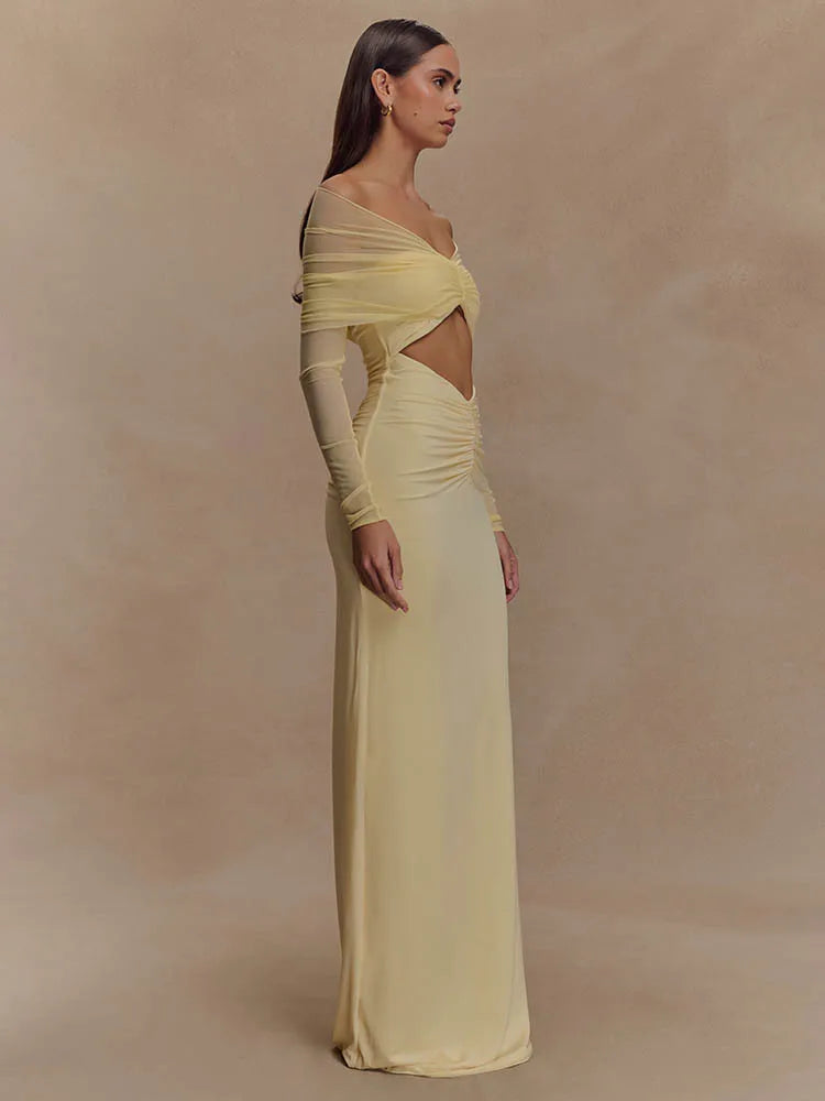 FJØRNA off-shoulder cut-out maxi dress with flowing fabric and stylish design, perfect for elegant summer occasions.