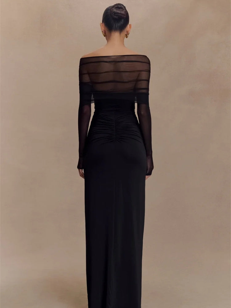 FJØRNA off-shoulder cut-out maxi dress with flowing fabric and stylish design, perfect for elegant summer occasions.
