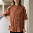 Orange summer women's blouse by FJØRNA with denim pockets, short sleeves, and a relaxed fit.