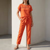Orange FJØRNA women's two-piece co-ord set with mesh pockets, stylish and comfortable casual outfit for women.