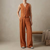 Orange linen sleeveless vest and high-waisted pleated trousers set by FJØRNA, styled as a chic 2-piece ensemble.