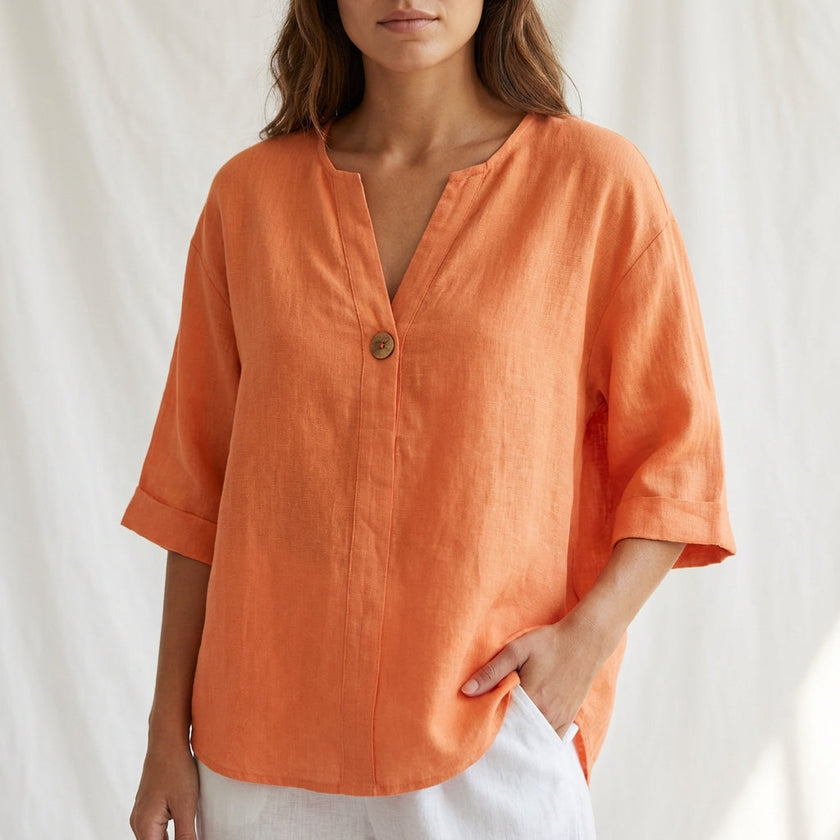 Orange women's summer blouse by FJØRNA featuring a V-neck, linen fabric, and button-front design for casual, breathable style.