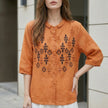 Orange women's summer blouse with geometric buttons, FJØRNA brand, featuring a stylish front button design and lightweight fabric.