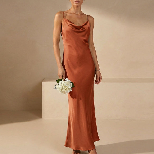 Orange FJØRNA slim fit sleeveless maxi dress with a cowl neck, showcasing its elegant flowy style and fitted silhouette.