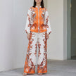 FJØRNA botanical zip-front top and wide-leg pants in orange, stylish 2-piece set with floral print and comfortable fit.
