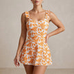 Orange women's summer swimsuit with ruffle floral design from FJØRNA, featuring a stylish and vibrant swimwear look.