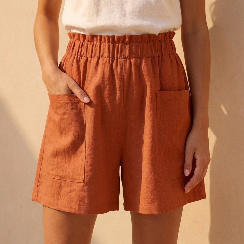 Orange women's summer shorts by FJØRNA with linen fabric and pockets, perfect for warm weather and casual wear.