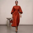 Orange FJØRNA batwing sleeve wrap front belted maxi dress with slit, showcasing elegant flowy fabric and stylish design.