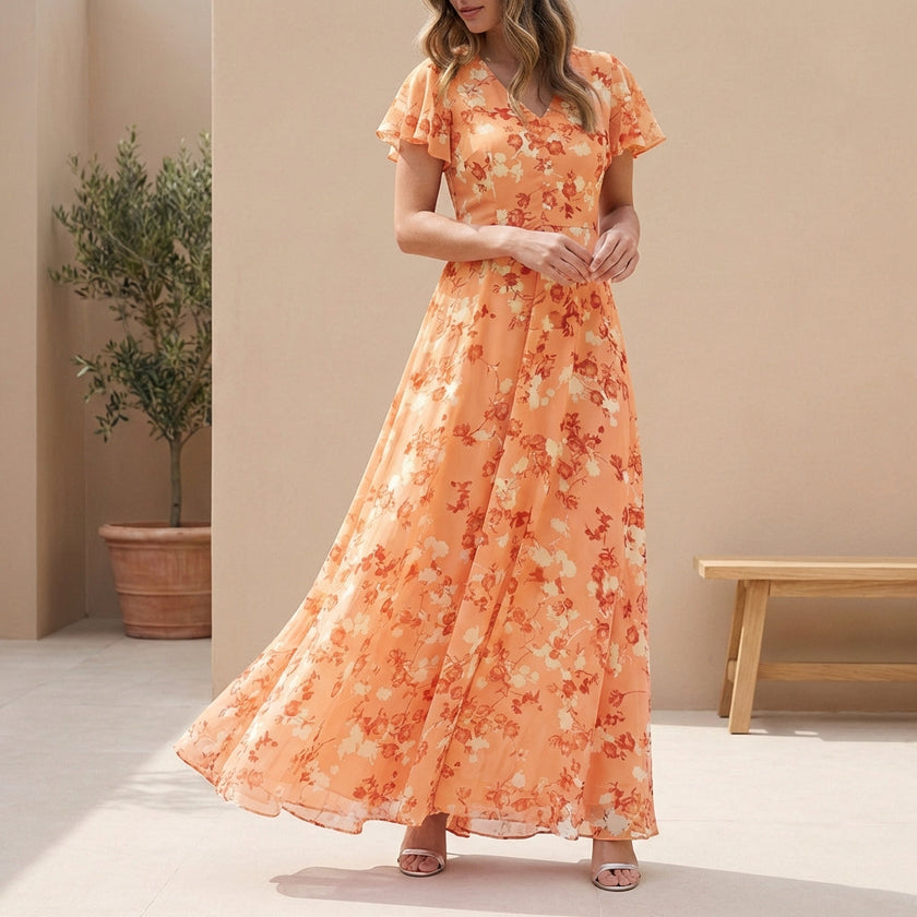 Orange FJØRNA A-line maxi dress with V-neck and flutter sleeves, flowing fabric, and elegant silhouette.