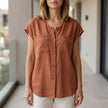 FJØRNA women's orange V-neck sleeveless summer blouse, casual top with lightweight fabric and stylish fit.