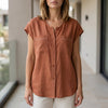 FJØRNA women's orange V-neck sleeveless summer blouse, casual top with lightweight fabric and stylish fit.
