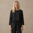 FJØRNA relaxed linen two-piece set with boat neck blouse and drawstring pants, casual and comfortable summer outfit.