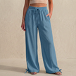 Peacock blue women's linen trousers with pockets and drawstring waist from FJØRNA, perfect for summer casual wear.