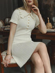 FJØRNA women's mini dress with a Peter Pan collar, perfect for party and day wear, shown in a stylish, close-up image.