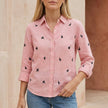 Pink and black women's summer swimsuit by FJØRNA with button front and stylish print, perfect for beach or pool outings.