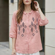 Pink summer blouse for women by FJØRNA with geometric buttons, featuring a stylish front design and lightweight fabric.