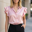 Pink satin ruffle summer blouse for women by FJØRNA, featuring a stylish and lightweight top with elegant ruffle details.
