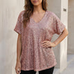 Pink FJØRNA women’s sequined V-neck top with short sleeves, draped style, ideal for evening wear.