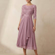 Pink embroidered FJØRNA A-line midi dress with sheer sleeves and side pockets, showcasing elegant detailing and flowy silhouette.