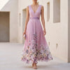 Pink floral A-line maxi dress with sleeveless V-neck by FJØRNA, flowing fabric and elegant design perfect for summer wear.