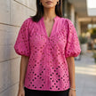 Pink FJØRNA women's summer blouse with V-neck, linen fabric, button front, casual style displayed on model.
