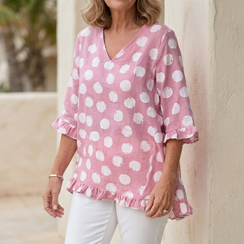 Pink FJØRNA women's mini dress with v-neck and ruffle details, showcasing a stylish and elegant fit for women.