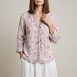 Pink floral V-neck long sleeve linen summer blouse for women by FJØRNA, shown on a model.