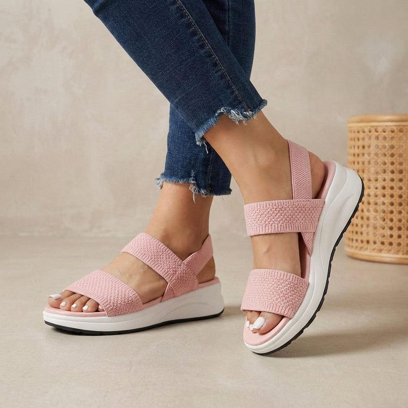Pink FJØRNA women's orthopedic sandals with adjustable straps and flowy design, showcasing their comfortable and stylish profile.