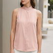 Pink FJØRNA women's summer blouse with v-neck, sleeveless design and high waist, perfect for warm weather.