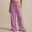 Pink women's linen summer trousers with pockets and drawstring from FJØRNA, featuring a comfortable relaxed fit.