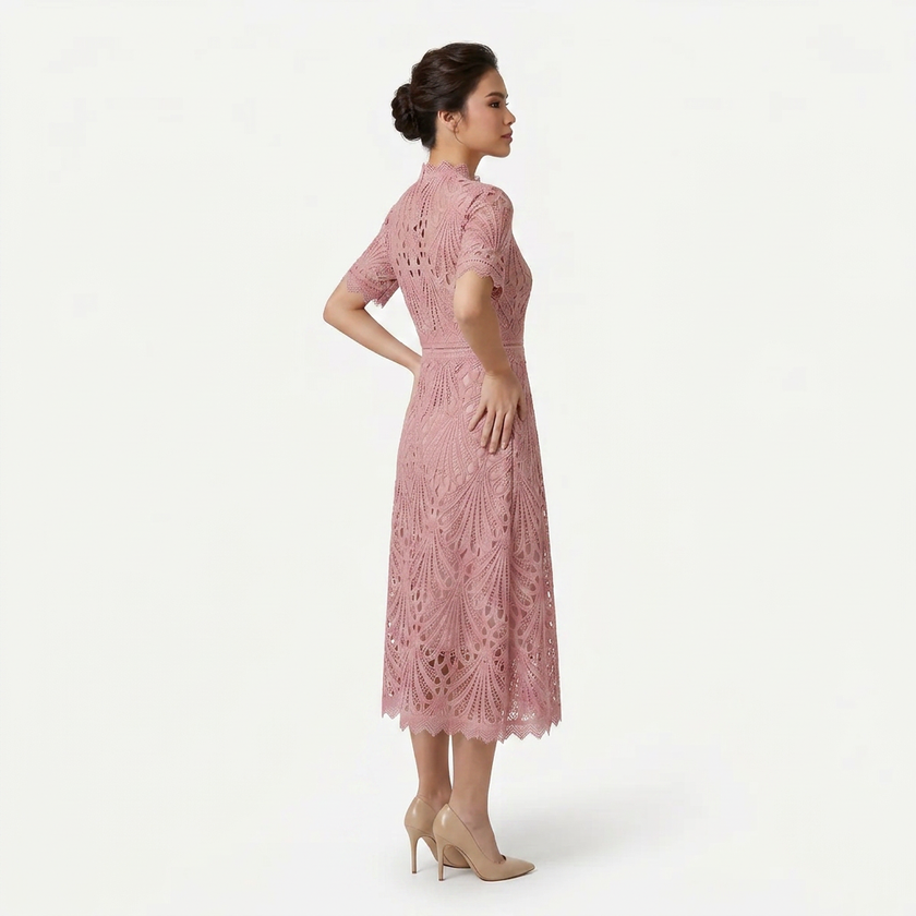 Side profile of FJØRNA women's pink lace midi dress with high neck, elegant silhouette, and refined cutwork detail.