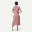 Back view of FJØRNA women's pink lace midi dress with high neck and refined cutwork detail, elegant and feminine silhouette.