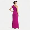 Pink women's one-shoulder maxi evening dress with asymmetric neckline, shown from the back profile, by FJØRNA.