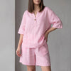 Pink oversized woven two-piece set with V-neck shirt and high-waist shorts by FJØRNA, casual and comfortable summer outfit.