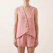 Pink relaxed sleeveless V-neck two-piece set with asymmetrical button front from FJØRNA, featuring casual, stylish design.
