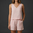 Pink women's summer two-piece co-ord set by FJØRNA featuring a pleated design and V-neck top.