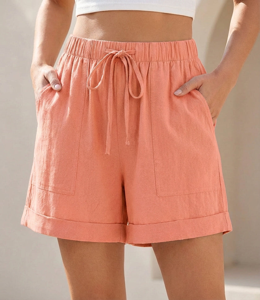Pink women's summer linen shorts with pockets and drawstring waist by FJØRNA, perfect for casual warm-weather wear.