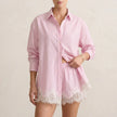 Pink FJØRNA relaxed lace-trimmed two-piece shirt and shorts set with a classic collar, perfect for casual wear.