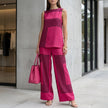 Pink loose sleeveless top with asymmetrical hem paired with wide-leg pants from FJØRNA 2-piece set.
