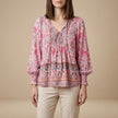 Pink floral long sleeve linen summer blouse for women by FJØRNA, showcasing a lightweight, feminine top with a relaxed fit.