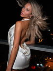 FJØRNA plunge satin mini dress featuring a deep V neckline, smooth satin fabric, and a fitted silhouette for elegant evening wear.