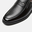 Close-up of men's leather slip-on business loafers by FJØRNA, highlighting the premium toe box and sleek design.
