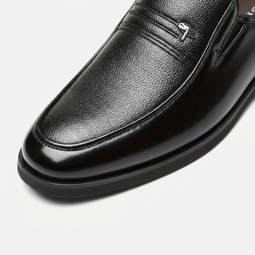 Close-up of men's leather slip-on business loafers by FJØRNA, highlighting the premium toe box and sleek design.