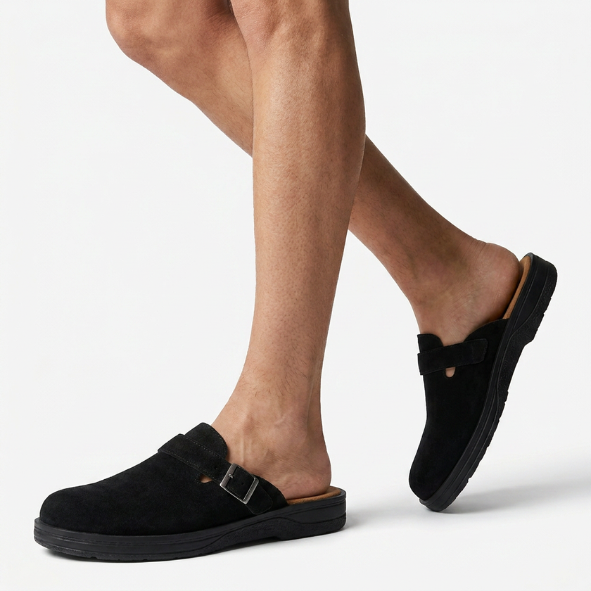 FJØRNA men's PU leather mule clogs with buckle strap, slip-on casual flat shoes shown on model's legs to feet.