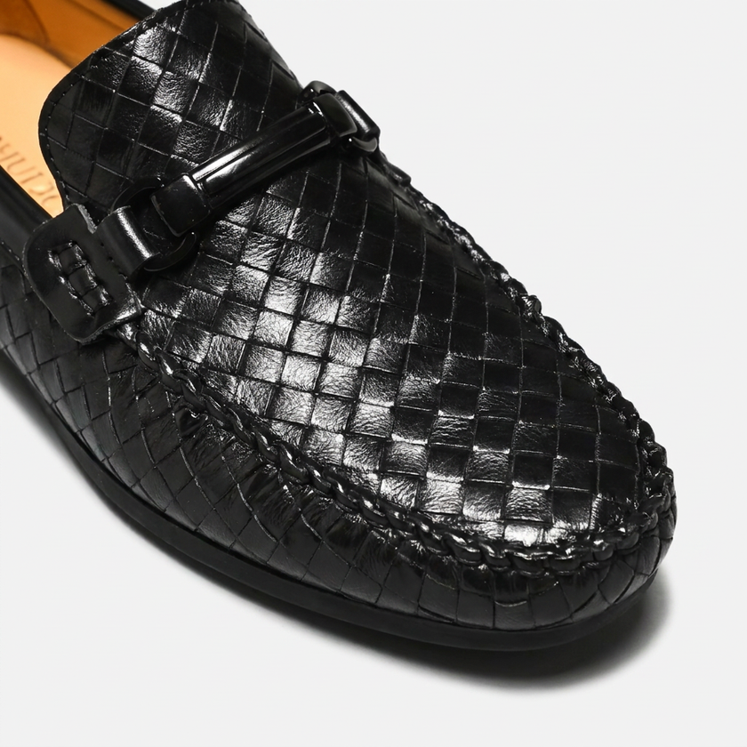 Close-up of men's woven leather slip-on driving loafers by FJØRNA, showcasing the detailed woven design and sleek leather finish.