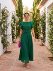 FJØRNA elegant mini dress for women with pleated design, suitable for evening wear, showcased in a high-end fashion photo.