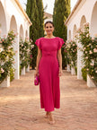FJØRNA elegant mini dress for women featuring pleated design, suitable for evening wear, in a professional high-end fashion photo.