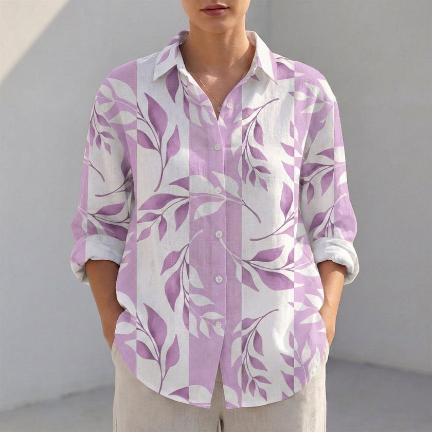Purple women's tunic shirt by FJØRNA with V-neck, collared design, and roll-tab sleeves, displayed flat on a white background.